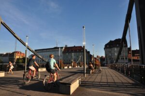 people riding bicycles on bridge during daytime